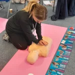 CPR chest compressions during first-aid training session.