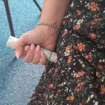 Demonstration of correct hand placement for holding and administering an auto-injector.