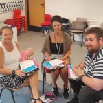 Group reviewing first aid worksheets and completing training tasks together.